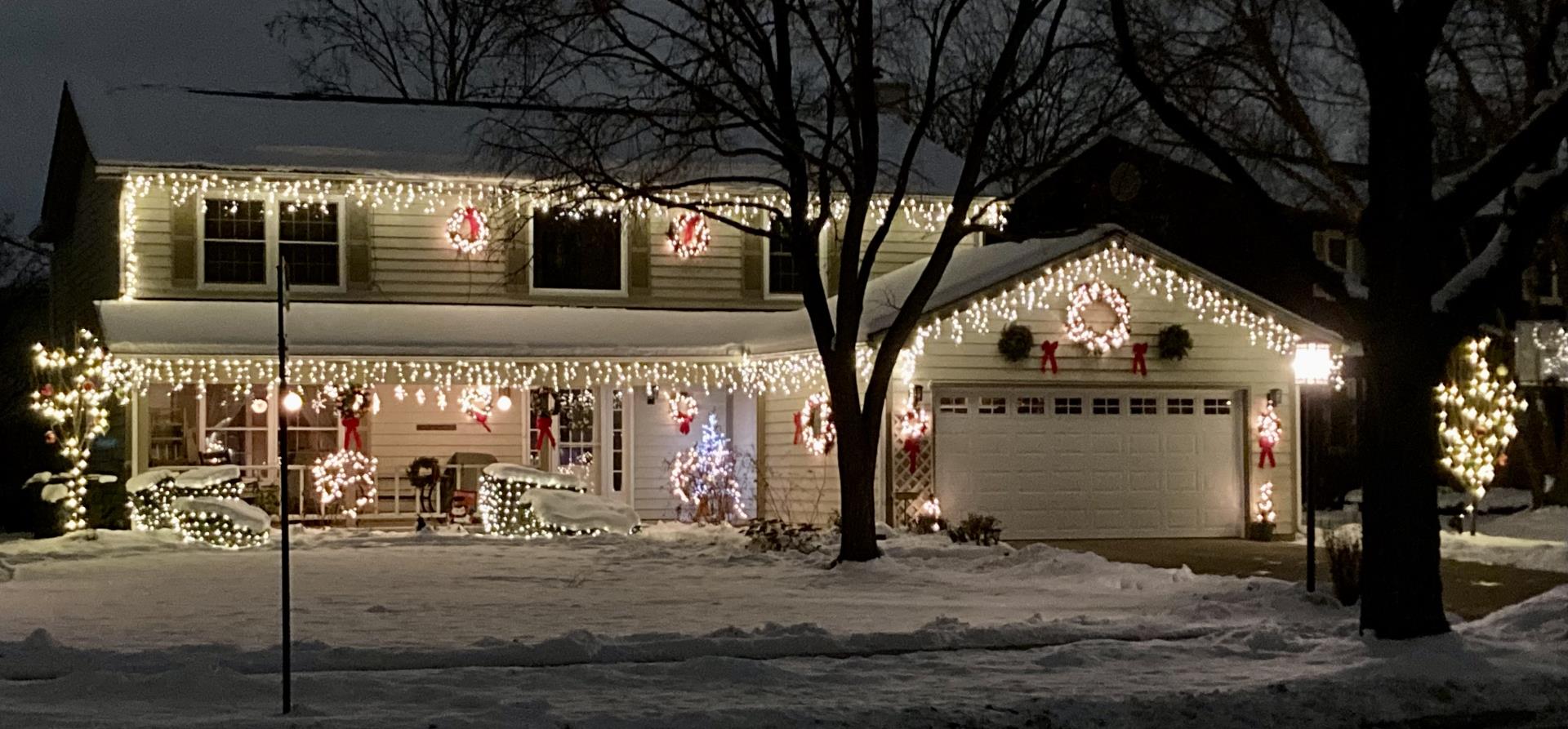 A house featuring bright Christmas lights on its exterior